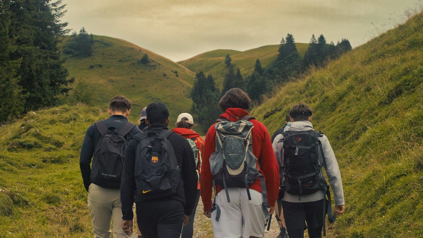 a group of people walking down a dirt road